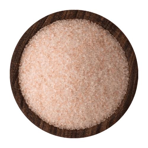 Shiny rose-colored Himalayan salt crystals of coarse size resting in a wooden bowl.