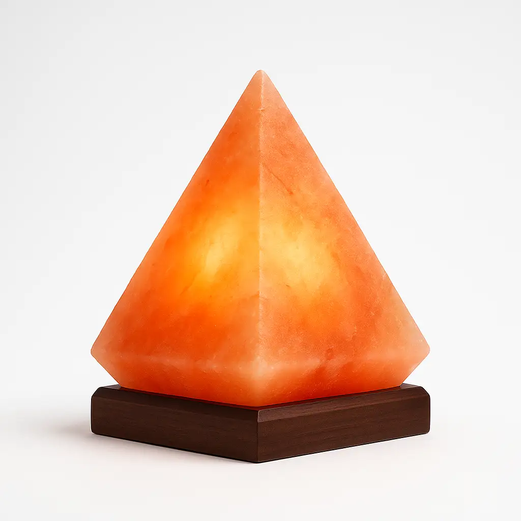 Pyramid-shaped Himalayan pink salt lamp glowing warmly on a wooden base, white background.